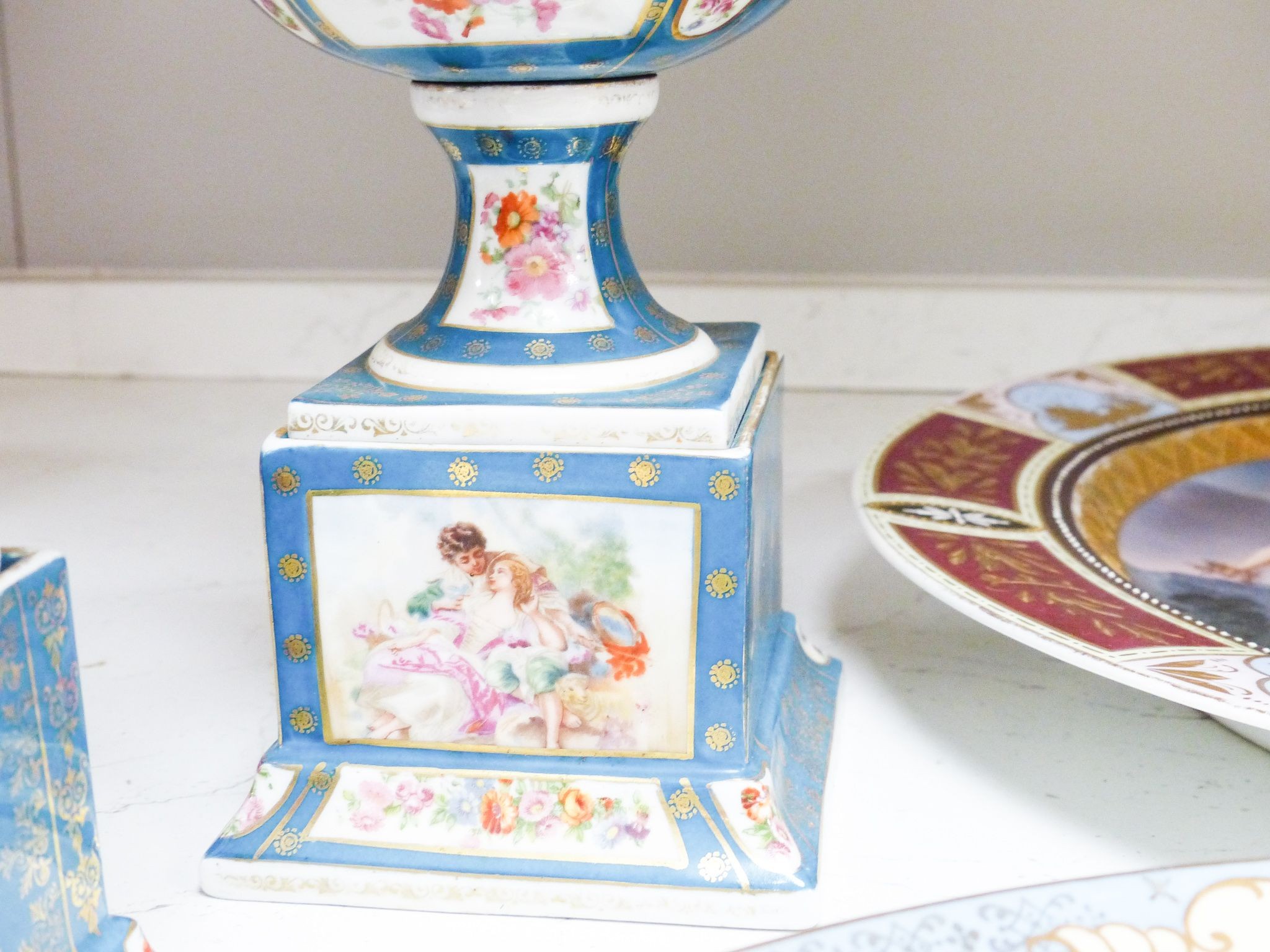 Two Vienna style porcelain chargers, 38cm and a similar pair of pedestal vases, 29cm, early 20th century